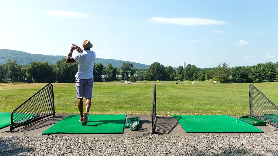 Golfer after his swing on a range
