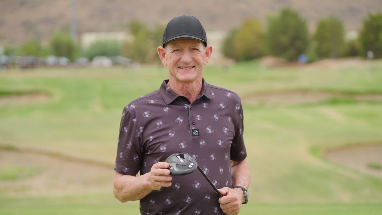 Golfer placing a golf ball on the tee