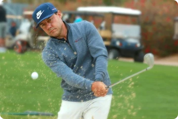 Image of Martin Chuck hitting a shot out of the bunker