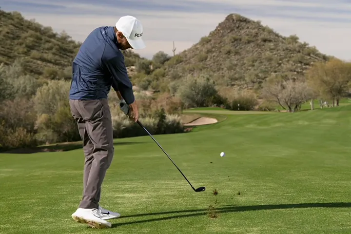Man using the AnyLie Hybrid to hit a pure straight shot down the fairway.