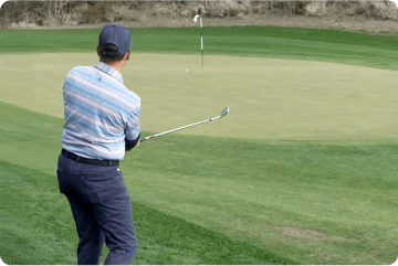 Image of a golfer chipping around the green